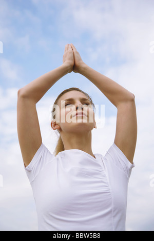 Young Woman meditating in a tree pose Stock Photo