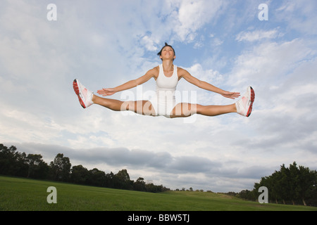 Young Woman jumping in the air Stock Photo