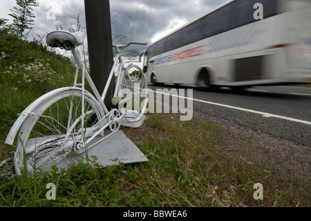 A Ghost Bike - a white painted cycle chained to the spot where a cyclist was killed in a road accident on the A23. Stock Photo