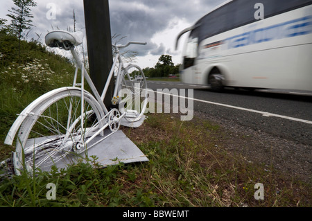 A Ghost Bike - a white painted cycle chained to the spot where a cyclist was killed in a road accident on the A23. Stock Photo