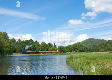 Steam train on Lakeside & Haverthwaite Railway, passing the River Leven, Lake District National Park, Cumbria, England UK Stock Photo