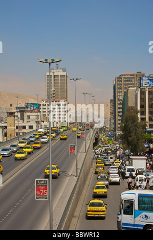 Busy street scene with passing traffic on Ath-Thawra Street, Damascus, Syria, Middle East Stock Photo