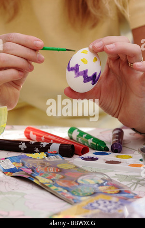A woman painting an Easter egg Stock Photo