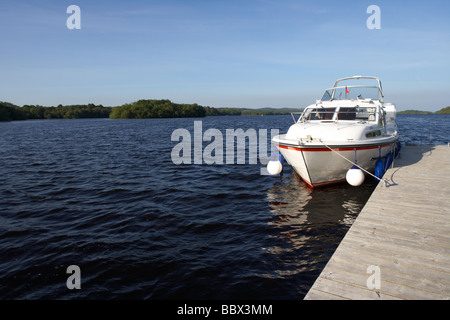 cabin cruiser moored at jetty on lower lough erne county fermanagh northern ireland uk Stock Photo