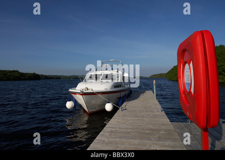 cabin cruiser moored at jetty with lifebelt on lower lough erne county fermanagh northern ireland uk Stock Photo