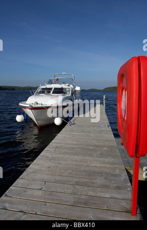 cabin cruiser moored at jetty with lifebelt on lower lough erne county fermanagh northern ireland uk Stock Photo