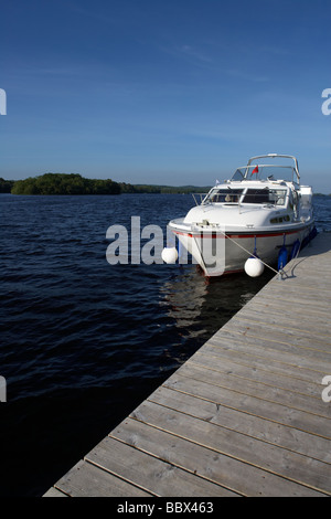 cabin cruiser moored at jetty on lower lough erne county fermanagh northern ireland uk Stock Photo