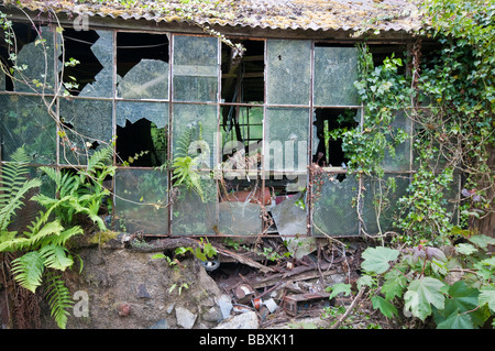 Broken windows at an abandoned workshop Stock Photo