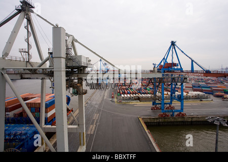 A high view of Post-Panamax cranes unloading containers at a European port. Stock Photo