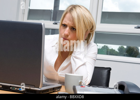 female office worker using laptop computer Stock Photo