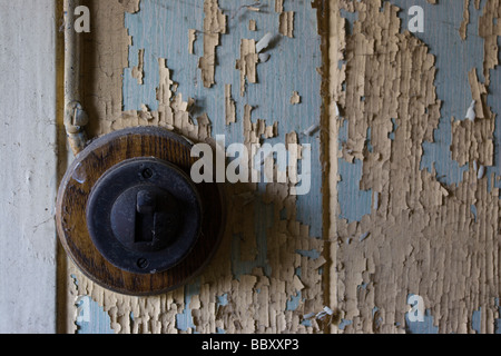 Light switch on wall with pealing paint Stock Photo