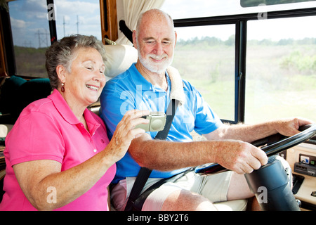 Senior couple using GPS to navigate their vacation motor home  Stock Photo