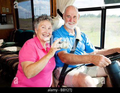 Senior couple using a GPS to navigate their motor home on the road  Stock Photo