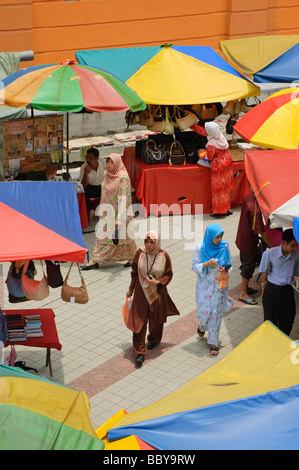 Market scene in Kuala Lumpur, capital of Malaysia, including Malay ladies in colourful hijab. Stock Photo