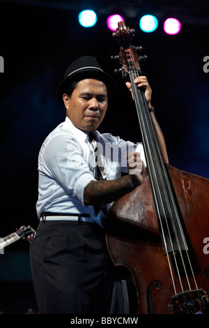 Jazz musician playing. Double bass player of the Brass Munkeys Jazz band performing on stage at the Hua Hin jazz festival 2009 Thailand S.E. Asia Stock Photo