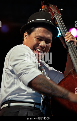 Jazz musician playing. Double bass player of the Brass Munkeys Jazz band performing on stage at the Hua Hin jazz festival 2009 Thailand S.E. Asia Stock Photo