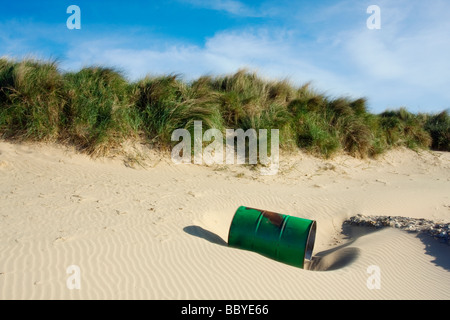 An abandoned oil drum lays washed up on the sand on the Dunes between Holme and Old Hunstanton Stock Photo