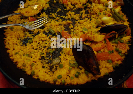 Skillet full of Spanish paella in a Barcelona, Spain restaurant. Stock Photo