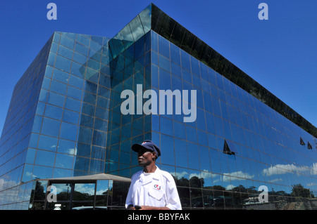 Security guard stands in front of the glassed Petroda Building in Lilongwe capital of Malawi Africa Stock Photo