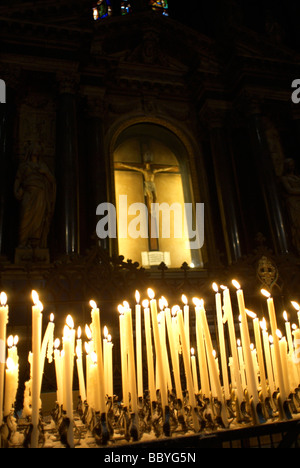 Votive candles burning in a church Stock Photo