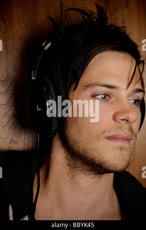 Young man listening to music on headphones Stock Photo