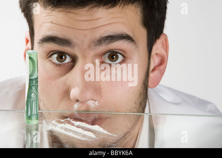 Guy smelling drug on the white background Stock Photo