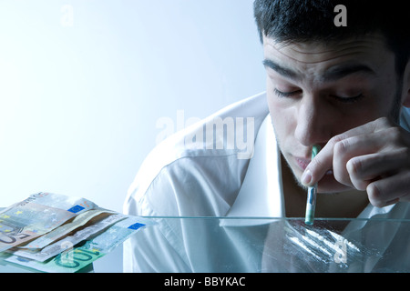 Guy smelling drug on the white background Stock Photo