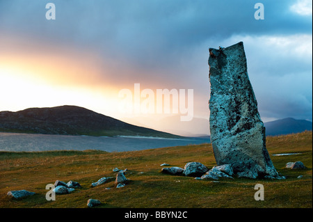 Mcleods standing stone at dusk, looking over sound of Taransay, Isle of Harris, Outer Hebrides, Scotland Stock Photo