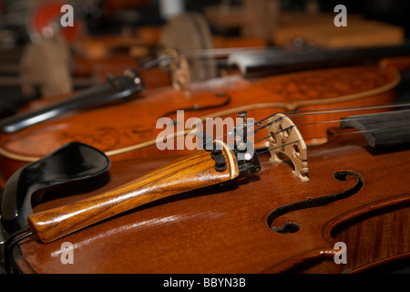 homemade handmade violins made of different materials and shapes on display Stock Photo