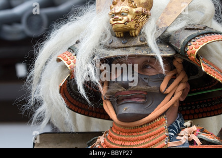 Man dressed in full samurai armor complete with kabuto helmet and mempo face mask to intimidate the enemy Stock Photo