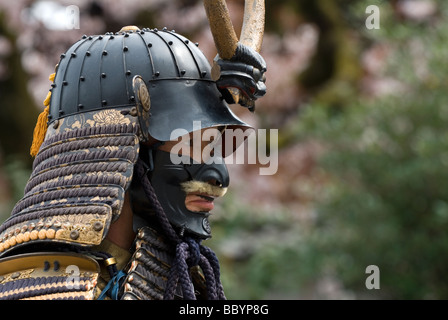 Man dressed in full samurai armor complete with kabuto helmet and mempo face mask to intimidate the enemy Stock Photo