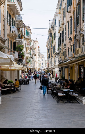 A narrow pedestrianised street bordered by tall old buildings in Corfu Town Stock Photo