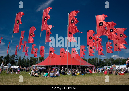 music tent and red flags blowing Womad festival England Stock Photo