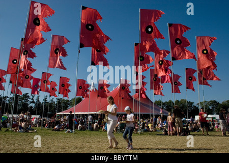 music tent and red flags blowing Womad festival England Stock Photo