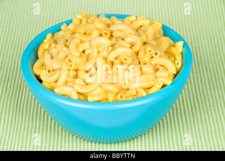 A bowl of macaroni and cheese on a green placemat Stock Photo