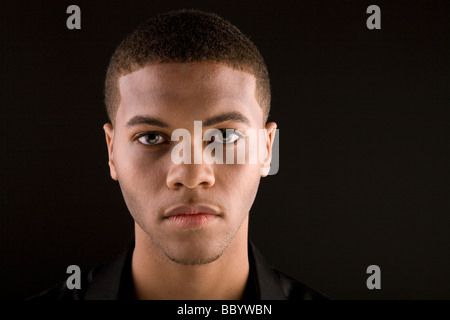 Young black man with dark background Stock Photo