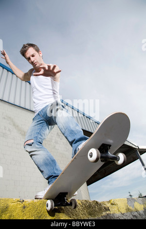 Skateboarder doing a slide Stock Photo