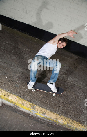 Skateboarder doing a slide Stock Photo