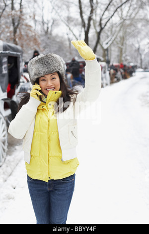 Korean woman talking on cell phone on snowy day Stock Photo