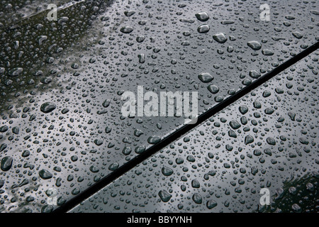 Raindrops on vehicle body. Stock Photo