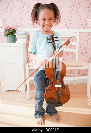 African girl holding violin Stock Photo