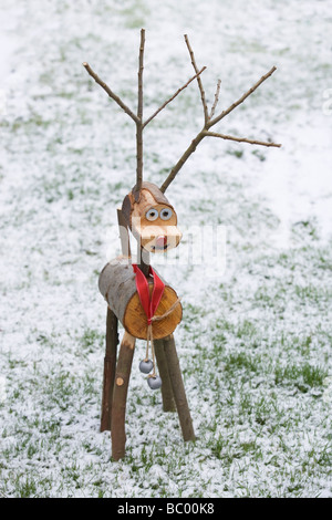 Home made wooden reindeer in the snow Stock Photo