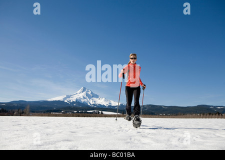 Young woman runs through snow near Mt. Hood, Oregon. Stock Photo