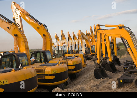 several big orange construction excavators standing on the ground Stock Photo