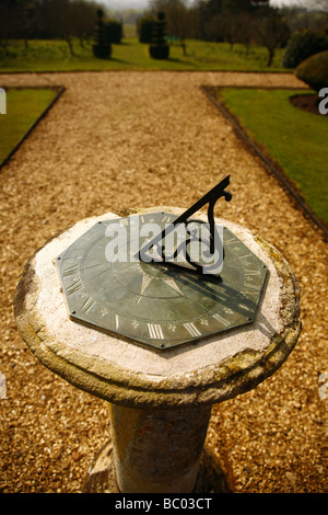 Pedestal,horizontal type sundial,made of brass and mounted on a stone plinth. Stock Photo