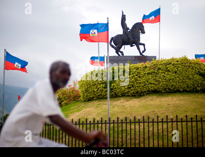 A bicyclist passes a monument to Jean Jacques Dessalines in the Champ de Mars plaza, Port-au-Prince, Haiti. Stock Photo
