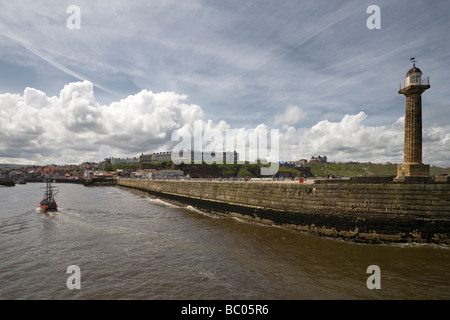 Lighthouse on the jetty at River Esk inlet Whitby Bay  North Yorkshire, England Stock Photo