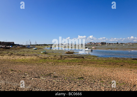 Boats aground at low tide by the creeks of Langstone Harbour at Eastney Portsmouth Hampshire UK Stock Photo