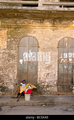 Haiti, Nord, Cap Haitien, Doors, Woman vendor. Stock Photo