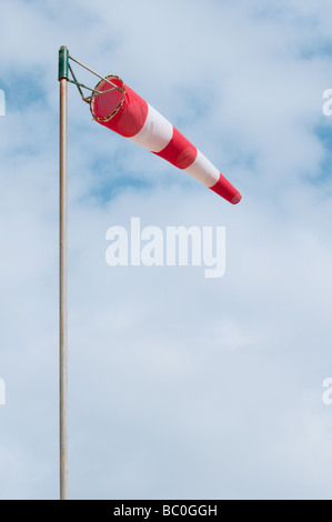 Red and white windsock on a pole Stock Photo